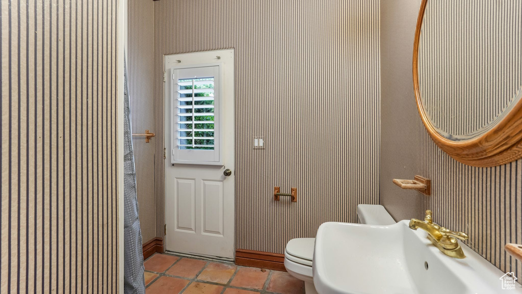 Bathroom with a sink and tile patterned floors