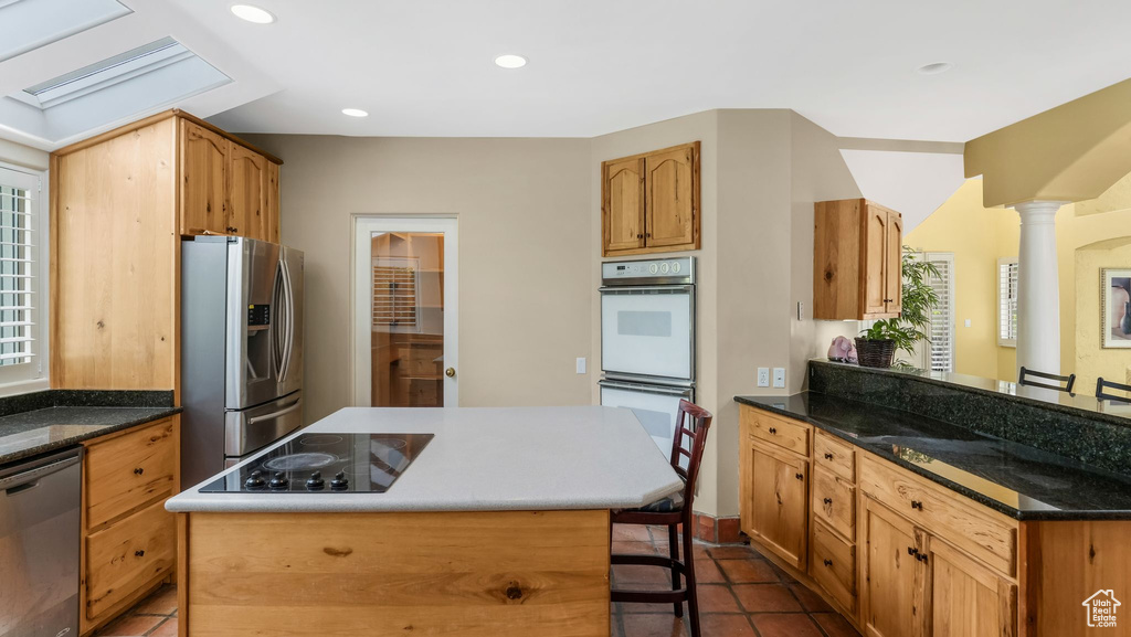 Kitchen featuring stainless steel appliances, a breakfast bar area, a peninsula, healthy amount of natural light, and recessed lighting