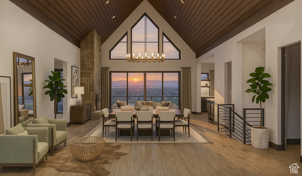Dining space featuring wood finished floors, high vaulted ceiling, wooden ceiling, a water view, and a chandelier