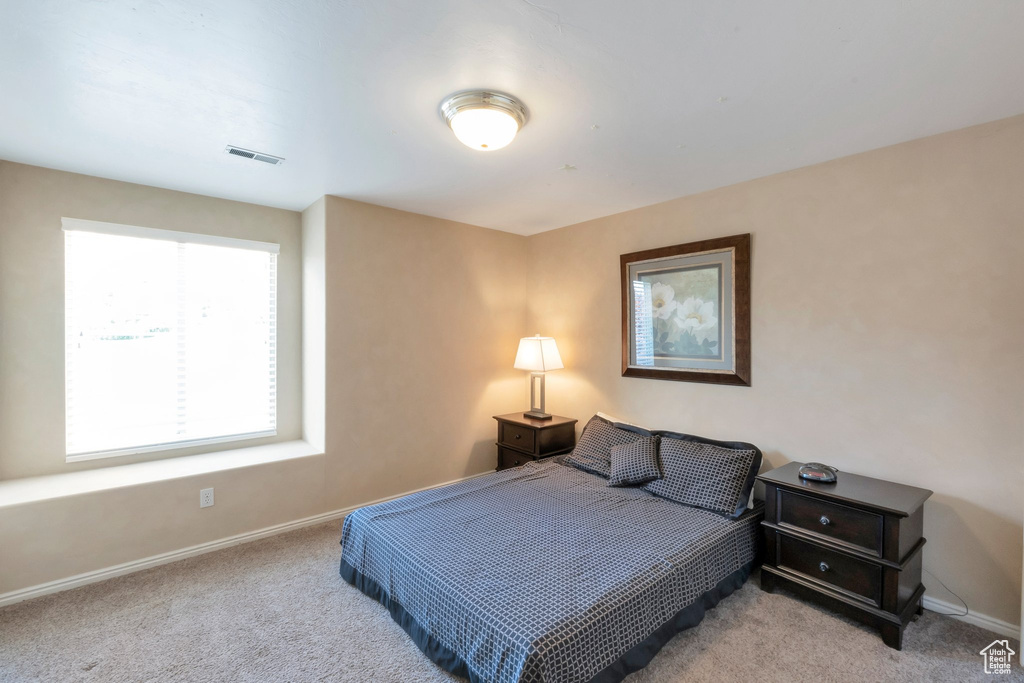 Carpeted bedroom with baseboards