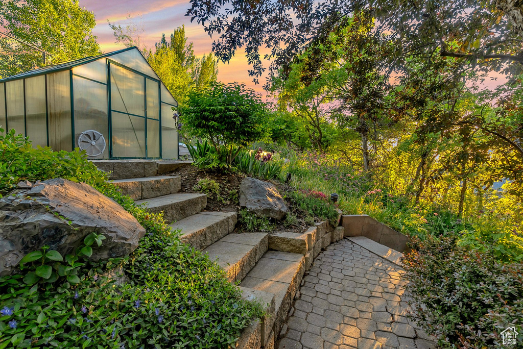 View of yard with a greenhouse and an outdoor structure