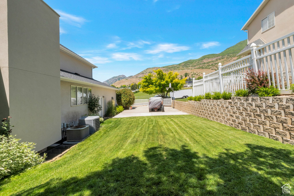 View of yard with a patio and a mountain view