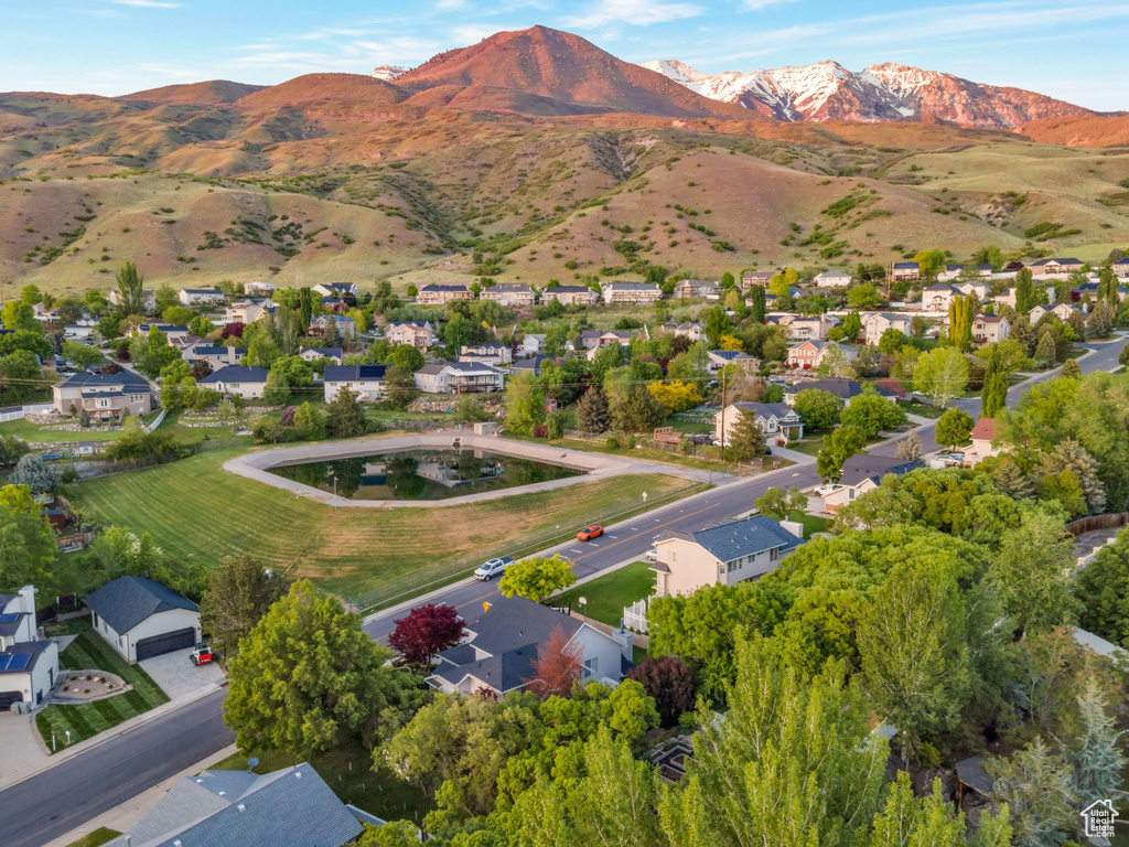 Aerial overview of property\\\\\\\'s location with a mountainous background and nearby suburban area