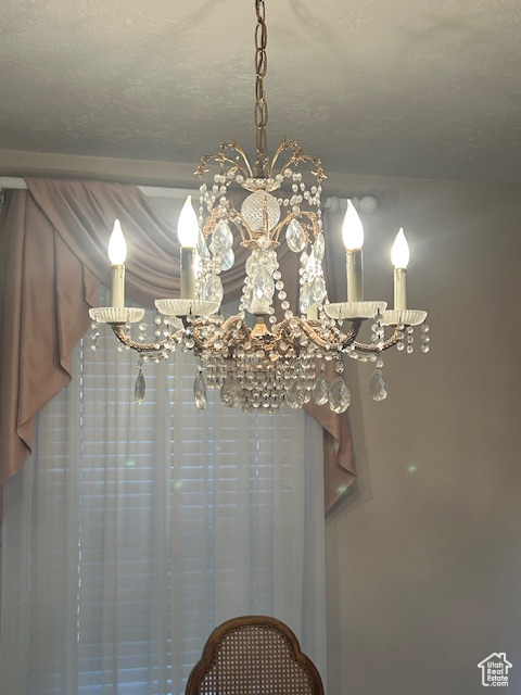 Detailed view of a chandelier and a textured ceiling