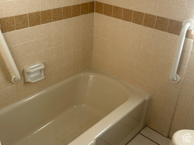 Full bathroom with a tub and tile patterned floors