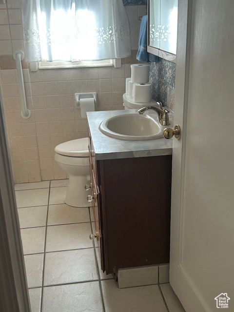 Bathroom with tile patterned flooring and vanity