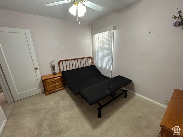 Bedroom featuring light carpet and a ceiling fan