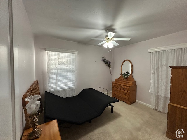 Bedroom featuring light colored carpet and ceiling fan