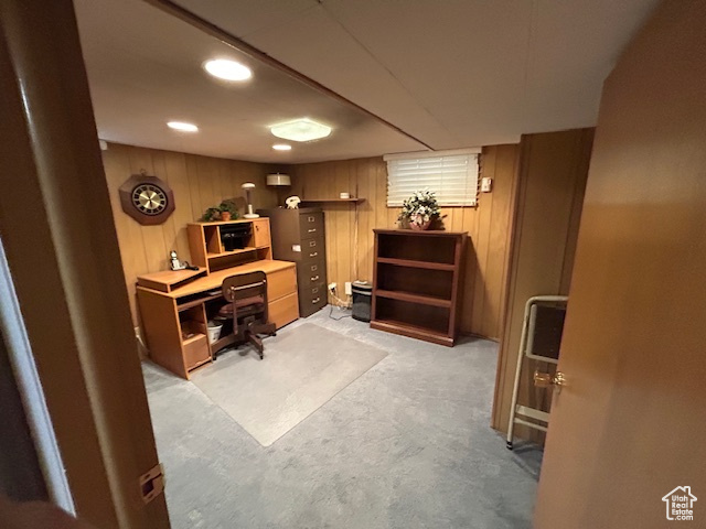 Office area with light colored carpet, wooden walls, and recessed lighting