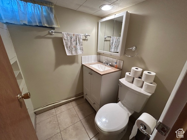Bathroom featuring vanity, tile patterned flooring, and a paneled ceiling