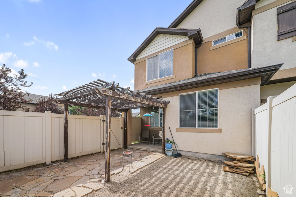 View of patio / terrace with a pergola and a gate