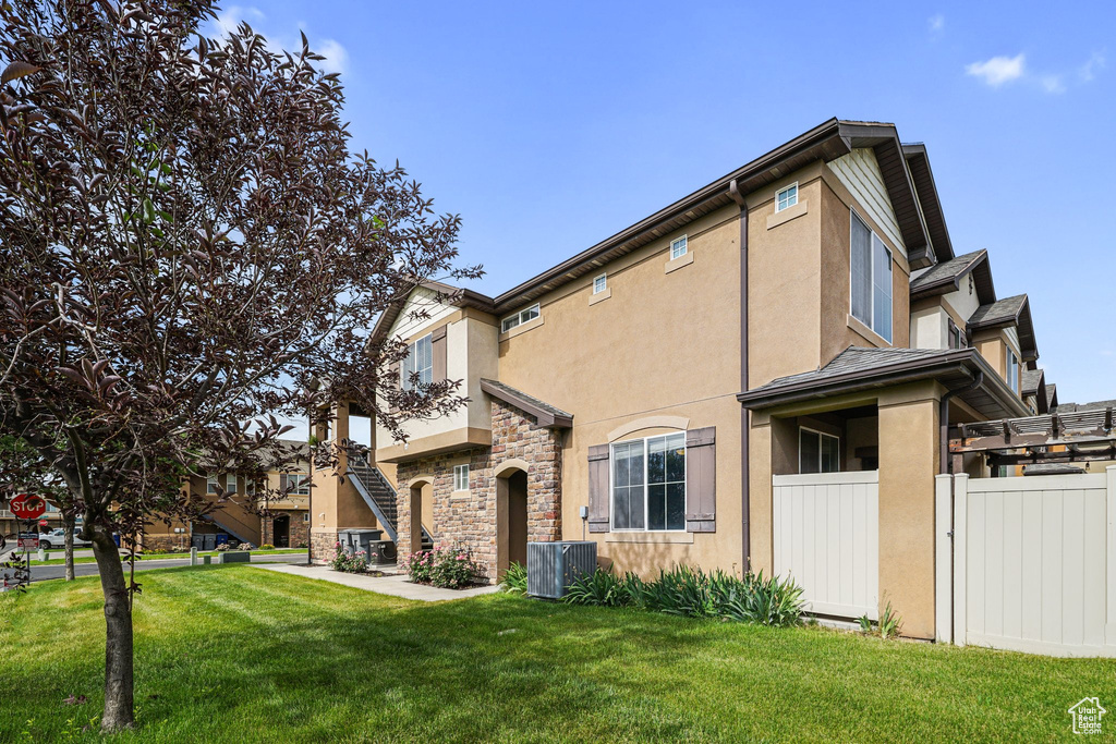 View of side of home with stucco siding and stone siding