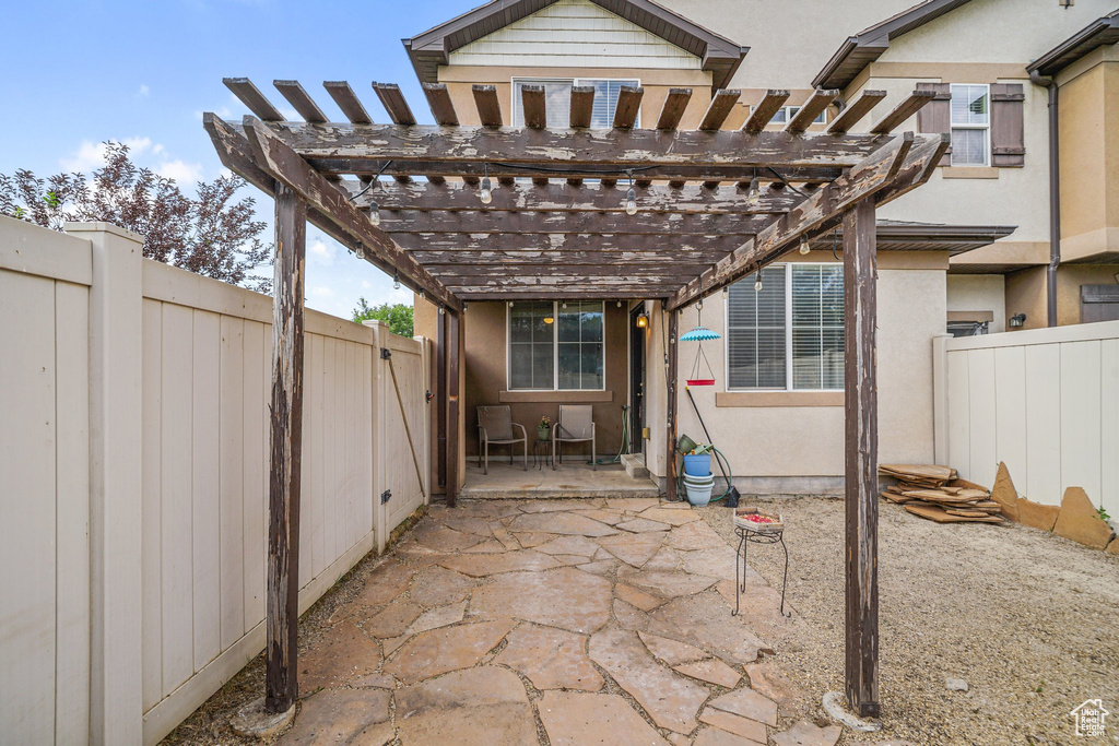 Fenced backyard featuring a patio area and a pergola