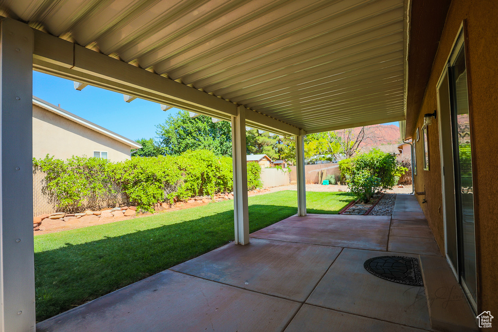 Fenced backyard with a patio