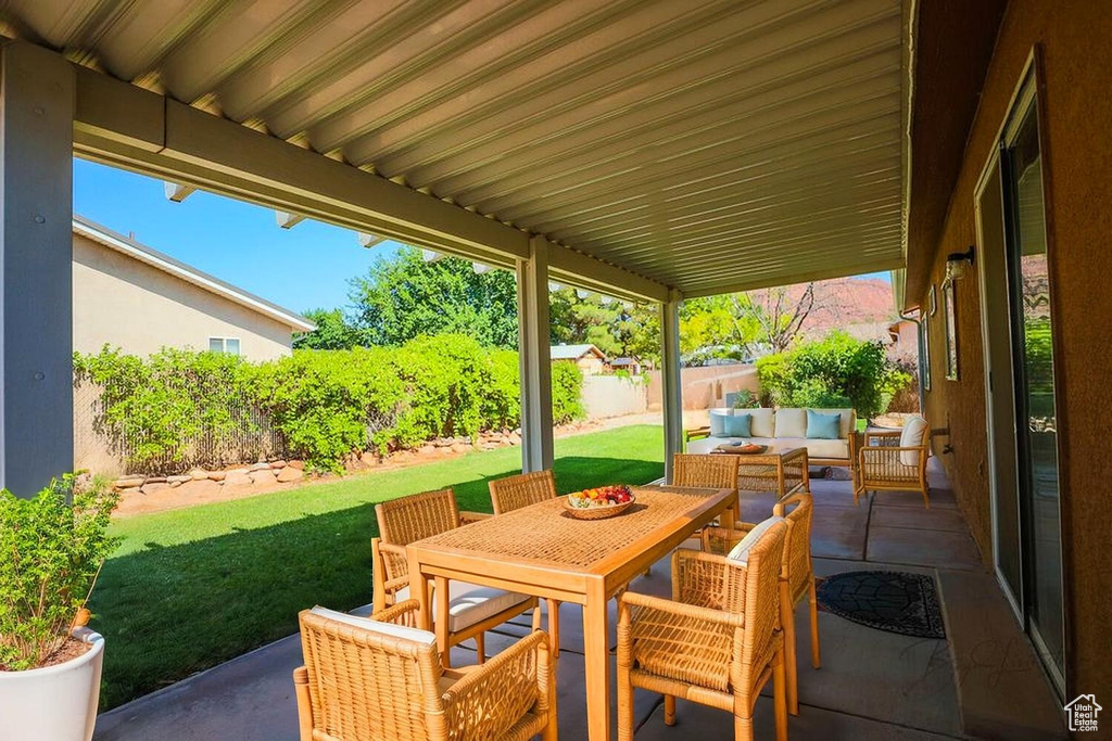 Fenced backyard with a patio area, outdoor lounge area, and outdoor dining area