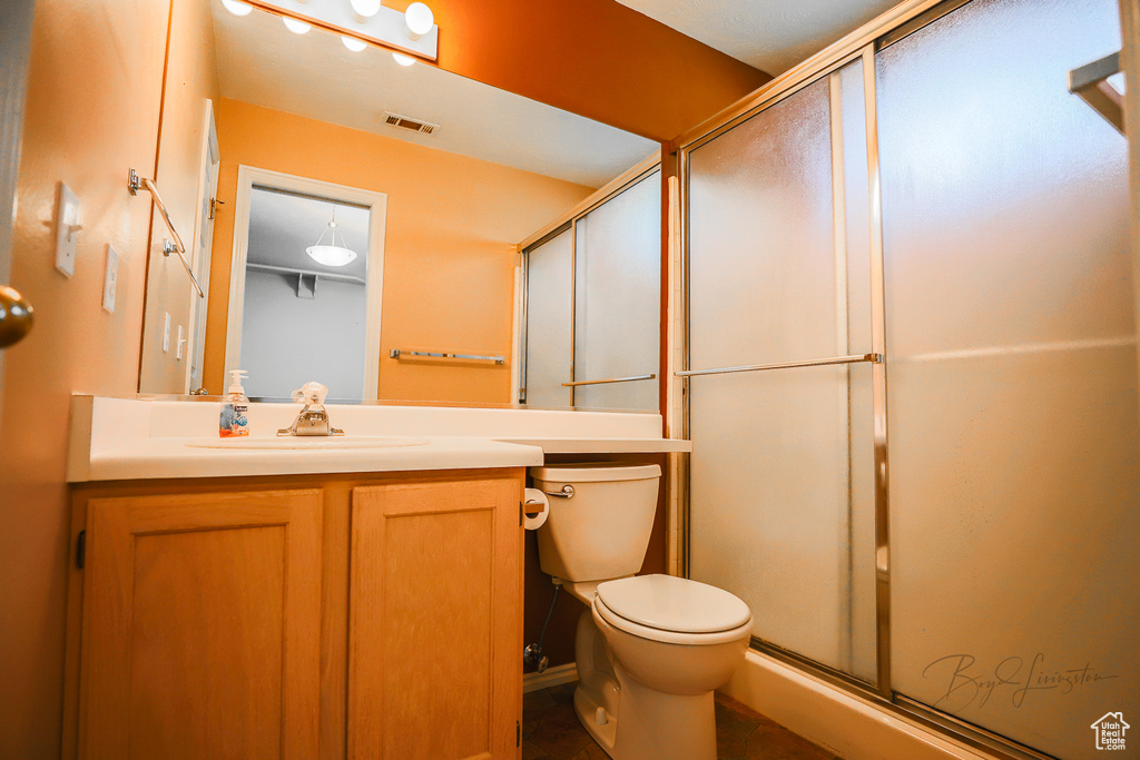Full bath with vanity and a stall shower