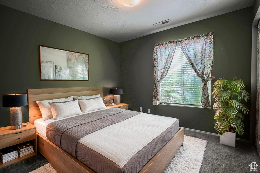 Carpeted bedroom featuring baseboards