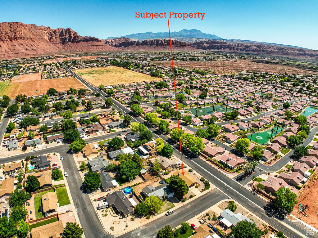 Aerial perspective of suburban area with a mountainous background