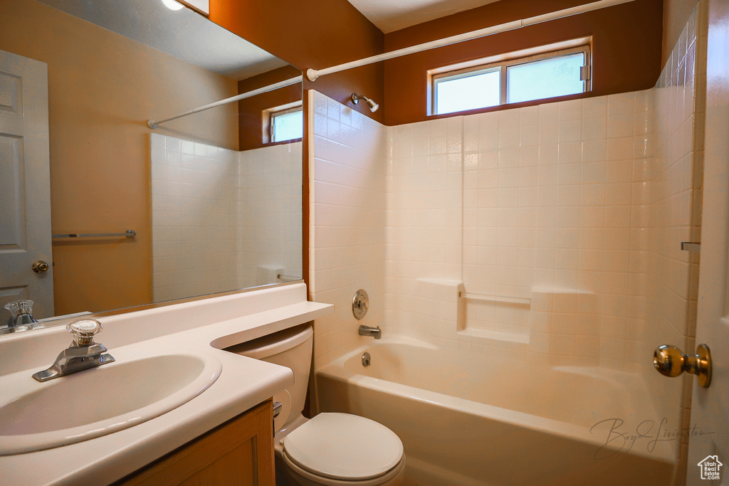Full bath with vanity, plenty of natural light, and bathing tub / shower combination