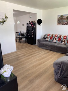 Living room with light wood finished floors and baseboards