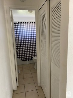 Hallway featuring light tile patterned floors
