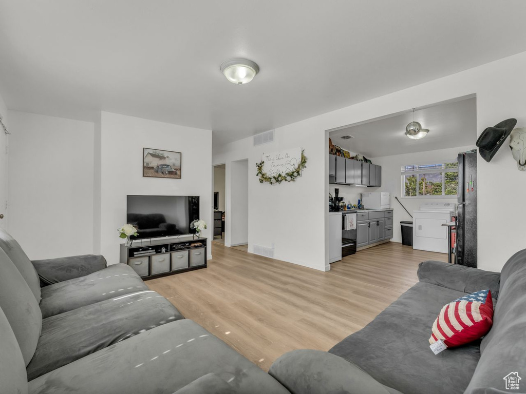 Living room featuring bar area and light wood-style floors