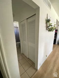 Hallway with light tile patterned flooring