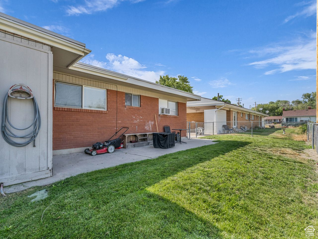 Rear view of house featuring brick siding and a patio