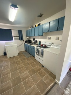 Kitchen with blue cabinets, electric stove, and light countertops