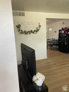Corridor featuring wood finished floors and baseboards