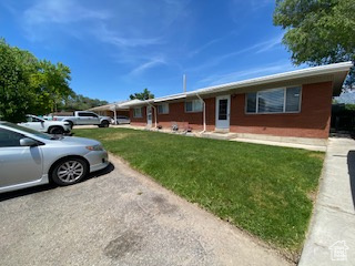 Single story home with a front yard