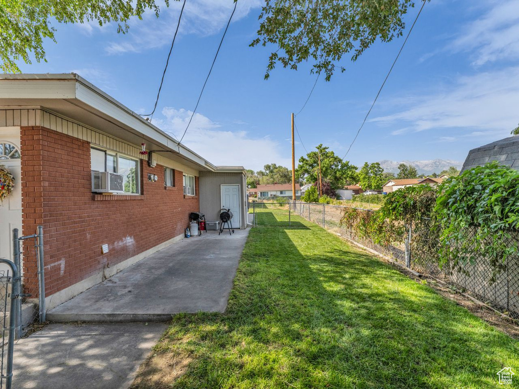 Fenced backyard featuring a patio area and cooling unit