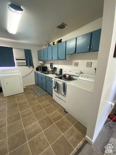 Kitchen with washer / clothes dryer, blue cabinets, and electric stove