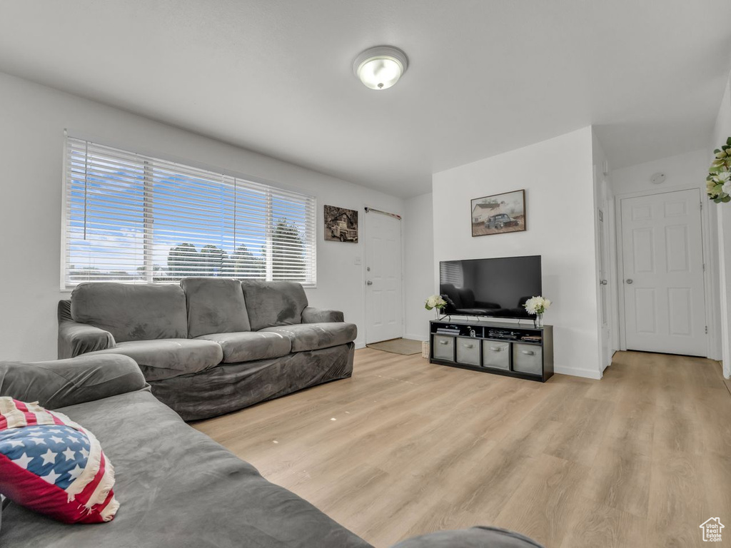 Living area with light wood-style flooring and baseboards