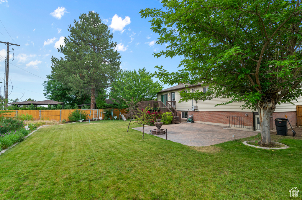 View of yard with a patio and a playground
