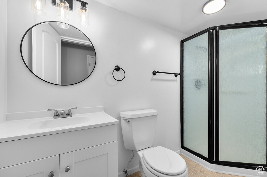 Bathroom with a shower stall and vanity