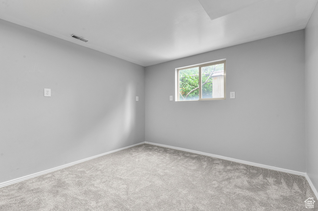 Empty room with carpet and baseboards