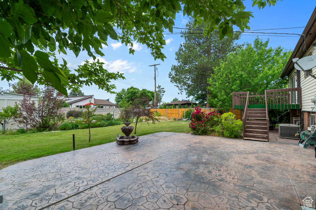 View of patio with stairs and a wooden deck