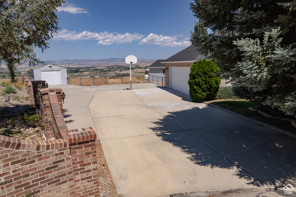 View of patio with driveway and an outbuilding