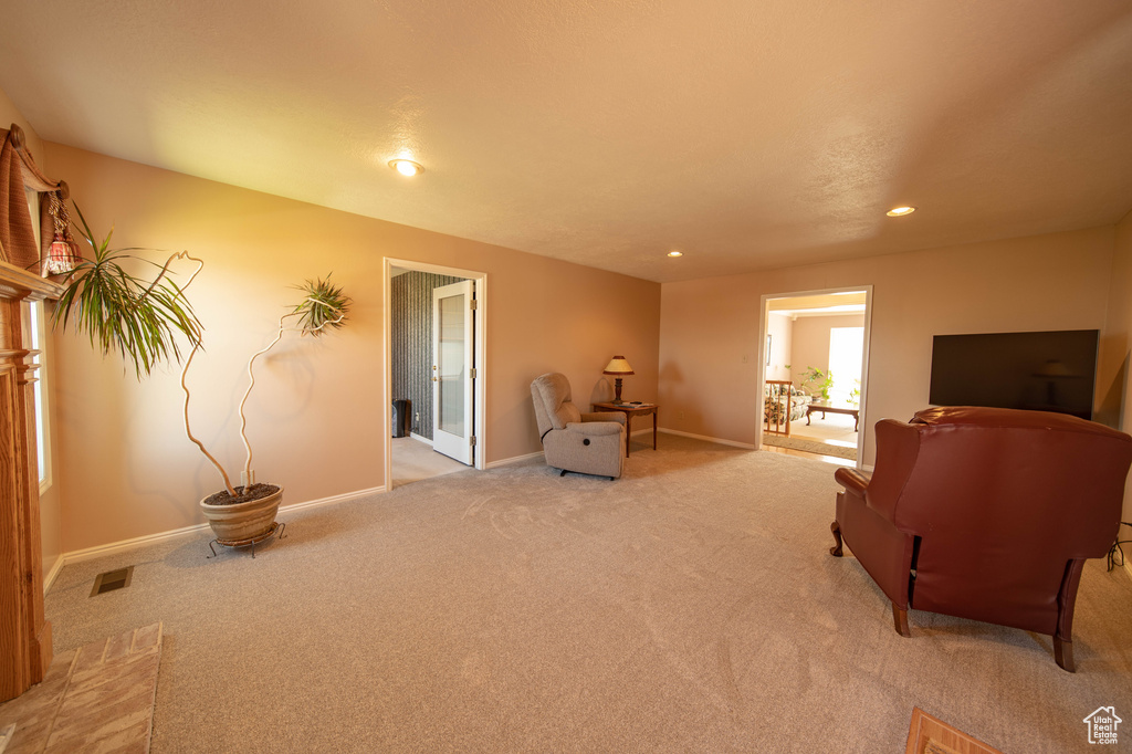Sitting room featuring light colored carpet and recessed lighting