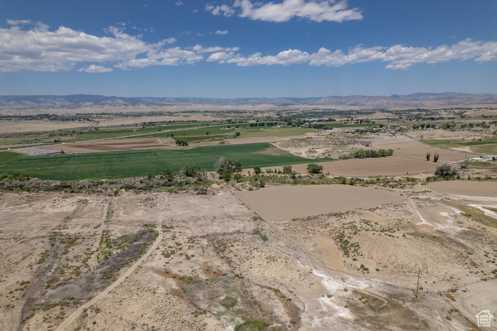 Aerial view of sparsely populated area featuring a mountain backdrop and a desert landscape