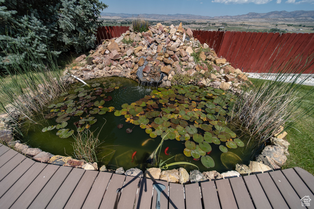 Exterior view of a small pond and a mountain backdrop