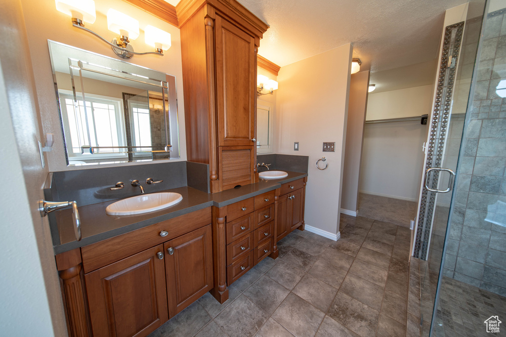 Bathroom featuring double vanity and a stall shower