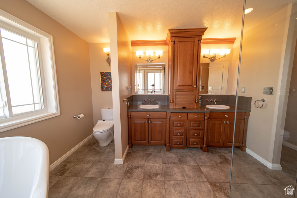 Full bath featuring double vanity and a freestanding tub
