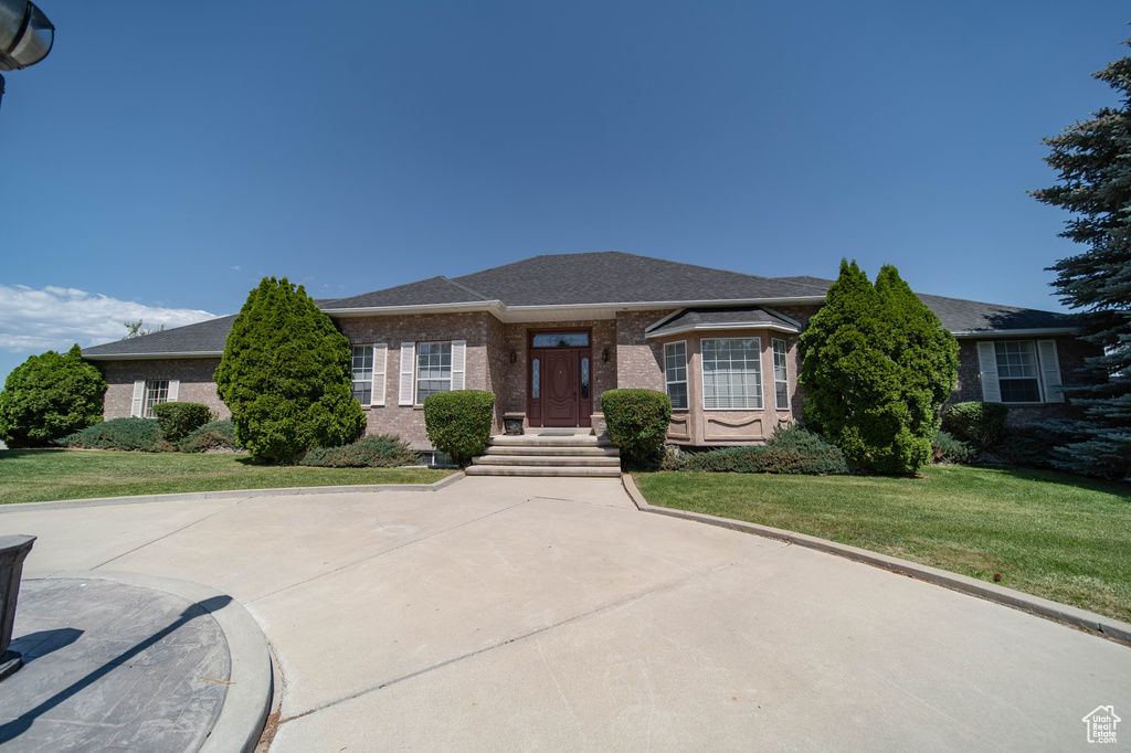 View of front of home featuring brick siding and a front lawn