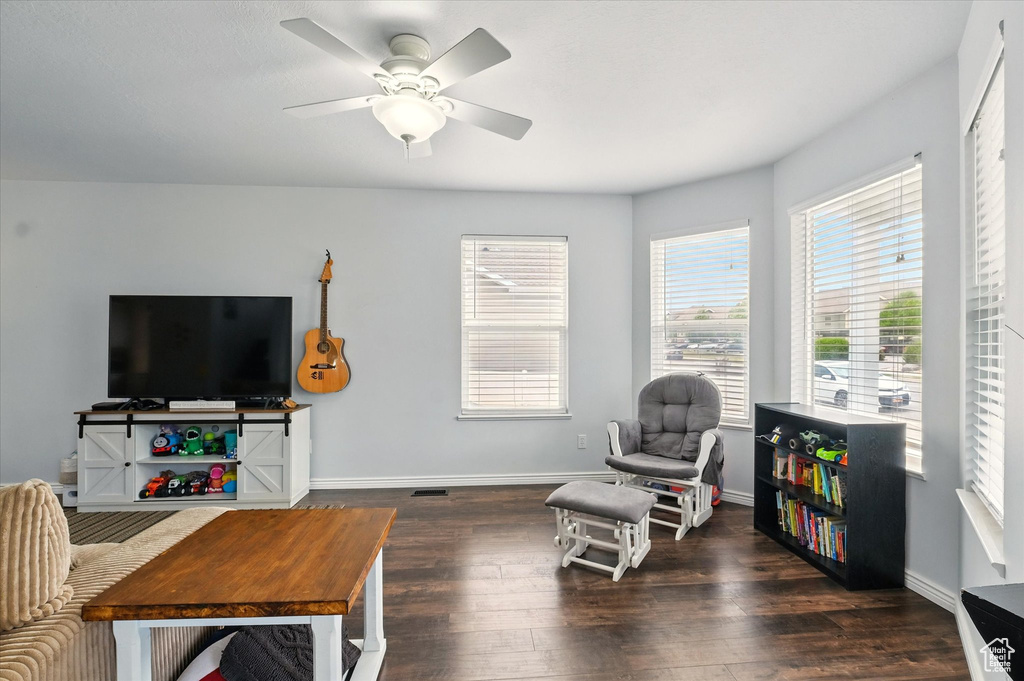 Living room featuring wood finished floors and a ceiling fan