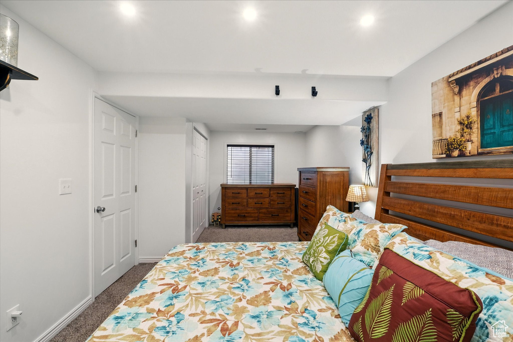 Carpeted bedroom with baseboards and recessed lighting