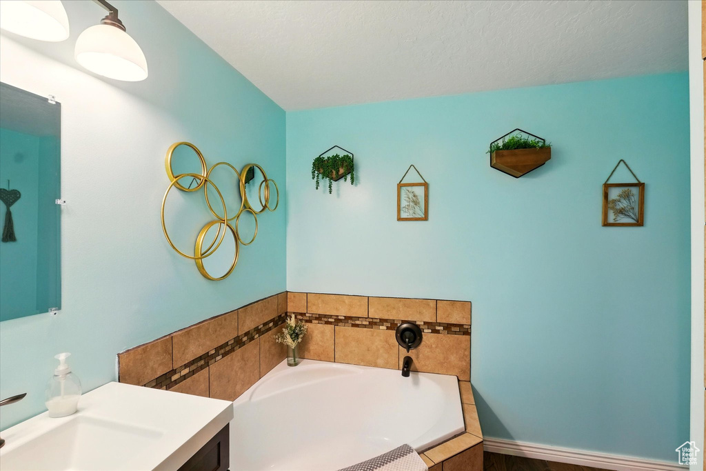 Bathroom featuring a bath and vanity