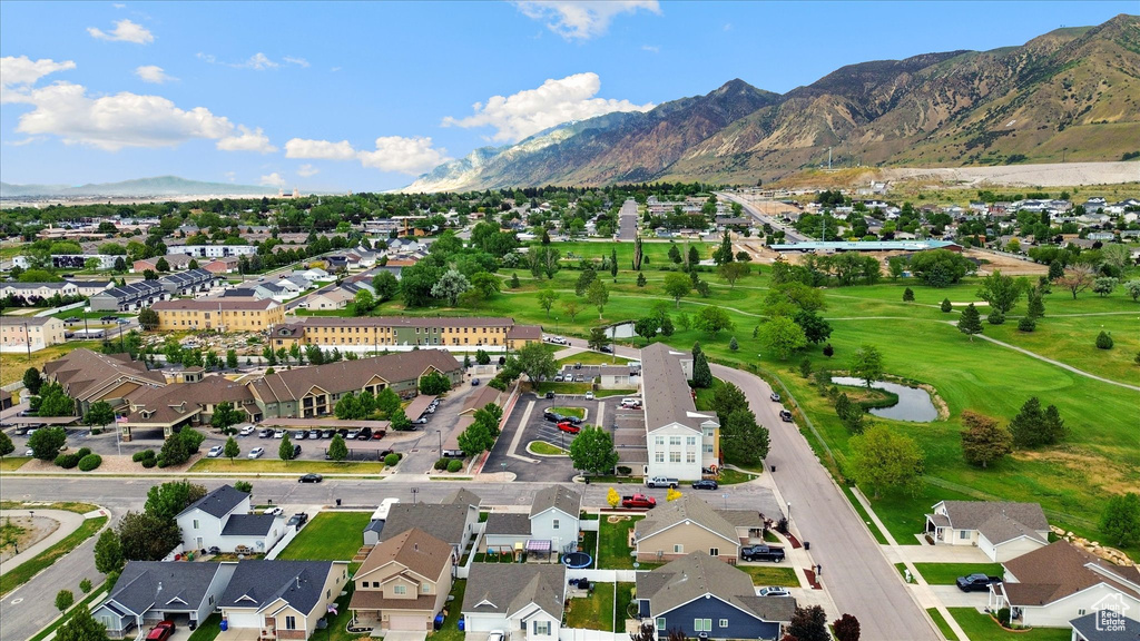 Aerial view of property and surrounding area featuring nearby suburban area