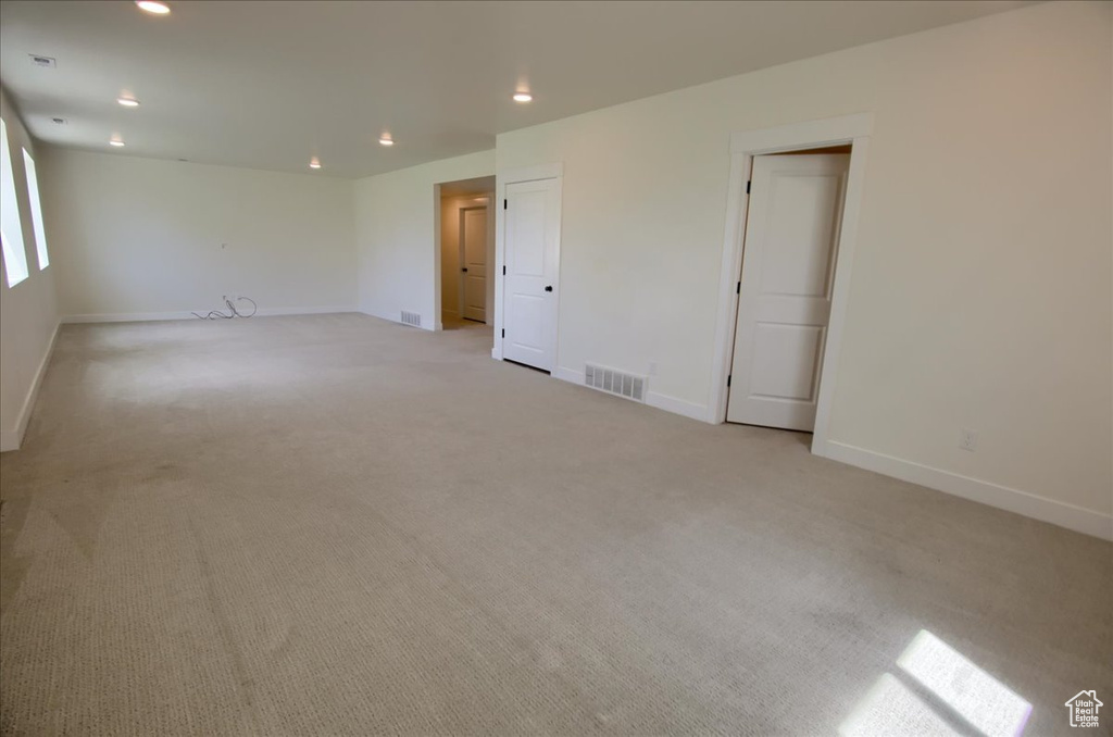 Spare room with light colored carpet and recessed lighting